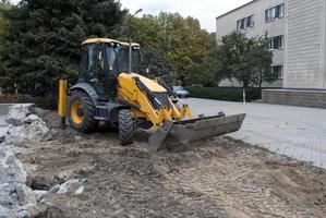 excavator stands on a construction site photo