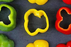 Slices of bell pepper, red, yellow and green photo