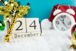 Christmas day theme decoration with hat santa and white retro clock.wood cube block calendar present date 26 and month December.copy space for text.Celebration Christmas and x'mas concept. photo