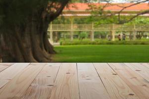 Empty table in front of blurry public park or garden with abstract background Ready for Create montage product display or design key visual layout banner or panoramic photo