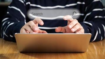 Search bar of internet browser and business man hand on laptop with visual screen search button on dark background, browsing information, internet data technology and datasearch engine concept photo