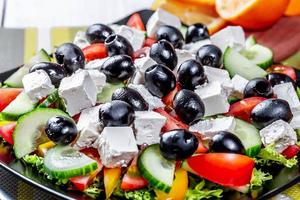 Greek salad with fresh vegetables, feta cheese and black olives. Top view