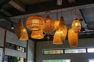 Hanging Bamboo Lamps in different Shapes with Light Bulbs inside a Restaurant and Cafe in Hoi An, Vietnam