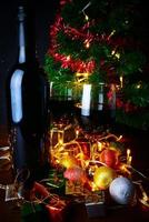 red wine in glass clear,Christmas tree and Ornament on wood table ready for celebrating.