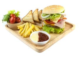 Pork hamburger Homemade with grilled bacon contains vegetables, cheese, lettuce, onion, chilli, spices in a wooden dish isolated on white backgroud photo