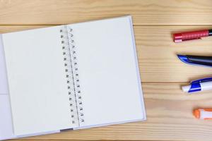 Note Book And Pen On Wooden Floor Background Space For Text. photo