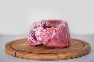 Frozen pork meat on a cutting board. photo