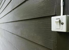 A switch on wooden wall. photo