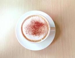 Hot coffee and white cup in the cafe photo