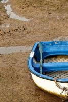 Lonely rowing boat in San Vicente de la Barquera, Cantabria, Spain.Vertical image. photo