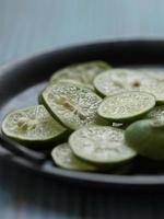 Close up view of lime slices on the vintage plate photo