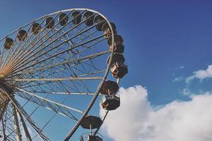 cut out of a ferris wheel against blue sky on a public festival, matt color look photo