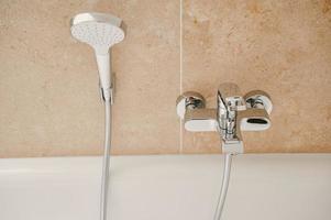 modern shower fitting on a wall in a bathroom photo