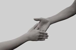 Hands take wrist in monochrome photo. concept of friendship, partnership, help and hope other. photo