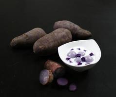 purple sweet potato in coconut milk on black table photo