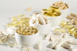 Food supplement oil filled fish oil, omega 3, omega 6, omega 9, vitamin A, vitamin D, vitamin E, flaxseed oil. photo