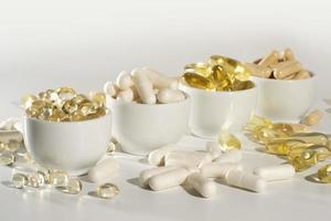 Food supplement oil filled fish oil, vitamin D, omega 3, omega 6, vitamin A, vitamin E, flaxseed oil. photo