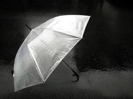 Umbrella in raining day. Umbrella is lying on the street. Blurred focus concept. photo