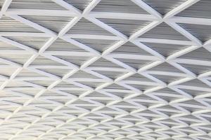 Futuristic bright metallic black and white abstract curved geometrical roof design and pattern photo