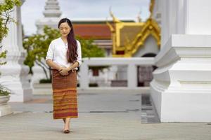 Buddhist asian woman is doing walking meditation around temple for peace and tranquil religion practice concept photo
