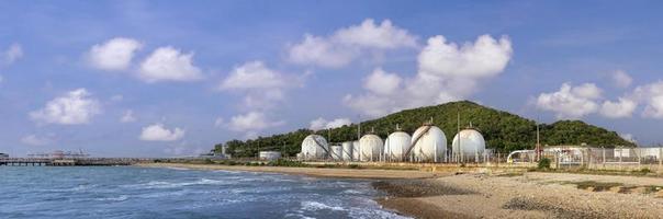 Panorama of petroleum crude oil silo container storage site located next to the sea shore with qualify waste water treatment system for environmental awareness and sustainable energy industry practice photo