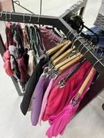 clothes on a hanger in the store. range of summer clothes. mall, women's fashion photo