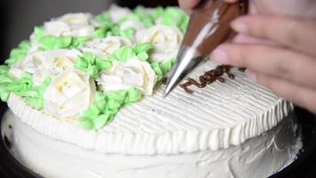 Closeup birthday cake decoration - people with homemade bakery concept video