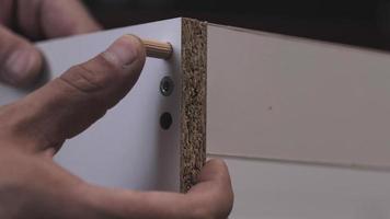 installation of wooden dowels in a hole in a chipboard video