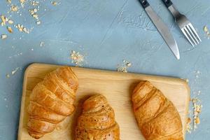 freshly baked croissants on black plate. French and American Croissants and Baked Pastries are enjoyed world wide. photo