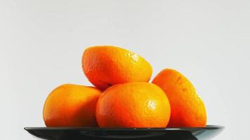 Fresh oranges rotate over white background video