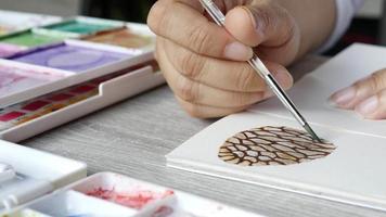 Lady is drawing pinecone using watercolor - people with Christmas celebration art hand draw watercolor concept video