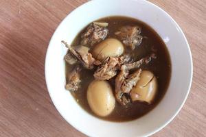 Stewed Eggs and pork on the brown table. photo