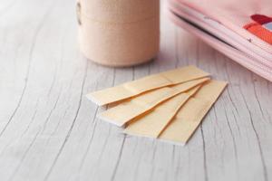 adhesive bandage and a bag on table photo