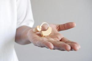 Hearing aid concept, a young man with hearing problems. photo