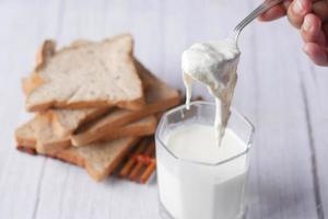 glass of whole cream milk on table , Cream of milk. photo