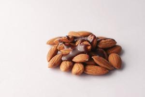 almond nut and chocolate liquid on white background photo