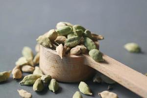 close up of Cardamom on a spoon on table photo