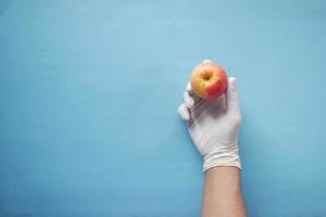 doctor's hand holding green apple while sited photo