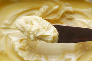 close up of fresh butter in a container photo