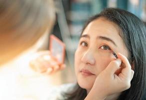 Young beautiful asian prepare applying make-up by professionist make-up artist. photo