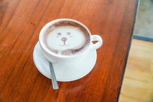 arte latte en forma de oso sobre una mesa de café sobre una mesa de madera. foto