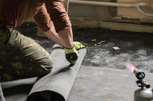 Waterproofing and resin on the floor, installation of waterproofing on concrete screed. photo