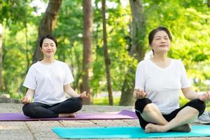 Image of Asian mother and daughter exercise at park photo