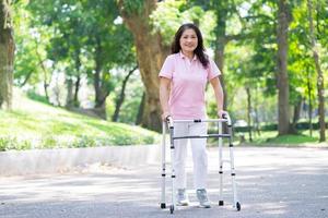 Image of middle age Asian woman practicing walking in the park photo