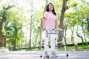 Image of middle age Asian woman practicing walking in the park photo