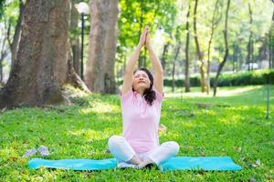 Image of middle age Asian woman exercise at park photo