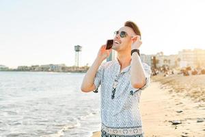 A man talking on the phone on the beach photo