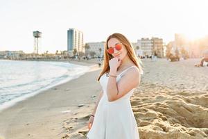 A happy red hair girl on the beach photo