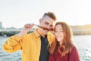 Happy couple of friends on the beach photo