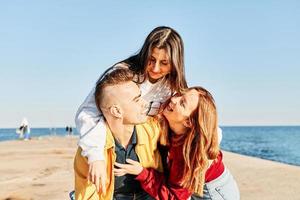 Young friends having fun at the beach photo